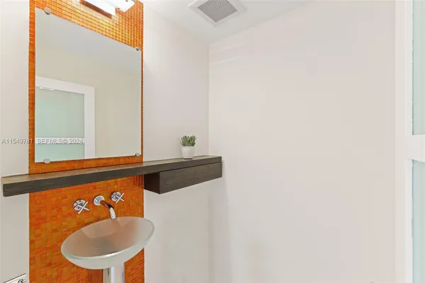 a spacious bedroom with a bed and a chair