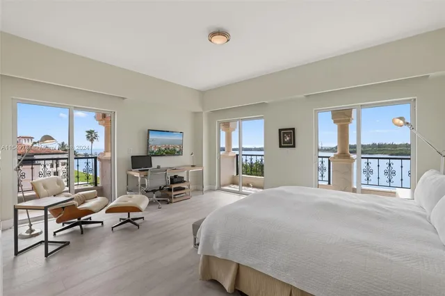 a spacious bedroom with a bed and a chair