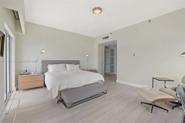 a bedroom with furniture and a chandelier