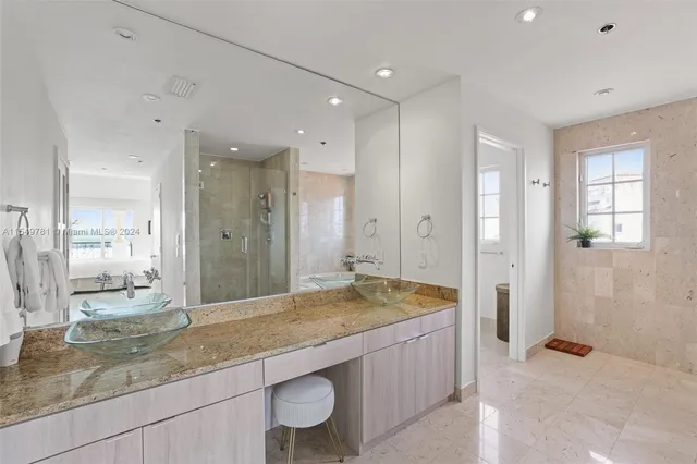 a bathroom with a tub a sink and a window