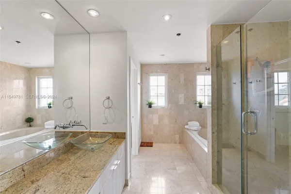 a bed room with two beds and a large window