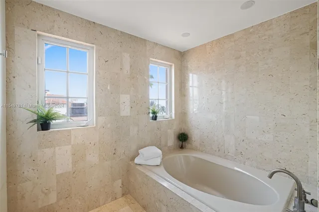 a bed room with two beds and a large window