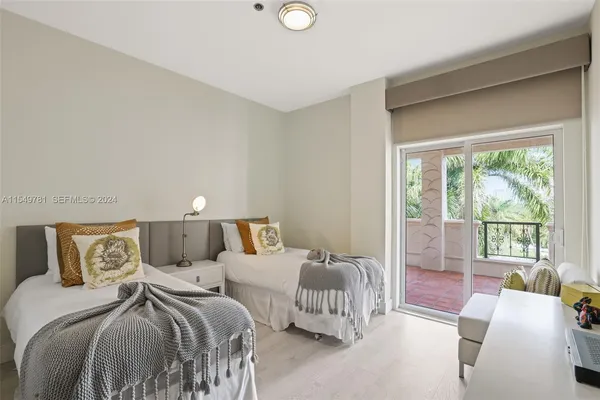 a bedroom with a large bed and a large window