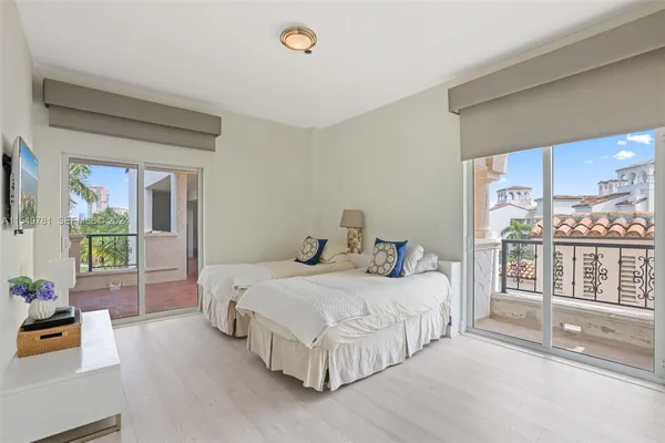 a spacious bedroom with a bed and a cabinet