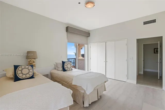 a picture of a room with a large window and wooden floor