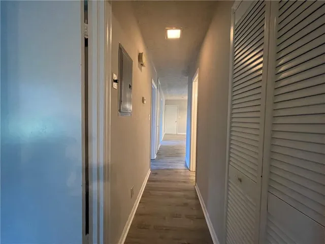 a view of a hallway with wooden shelves