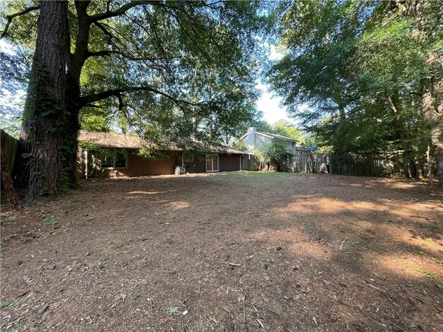 a view of a house with large tree