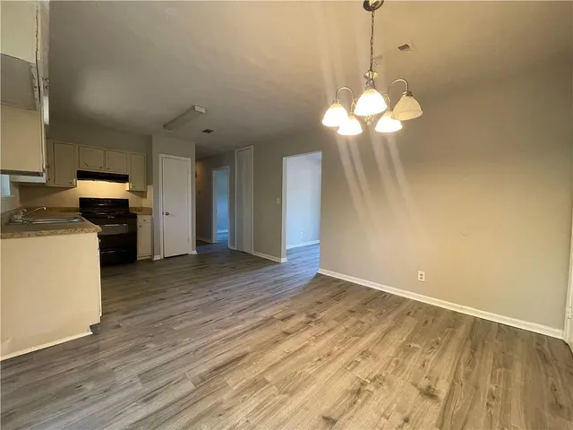 a view of a kitchen with a dishwasher cabinets and wooden floor