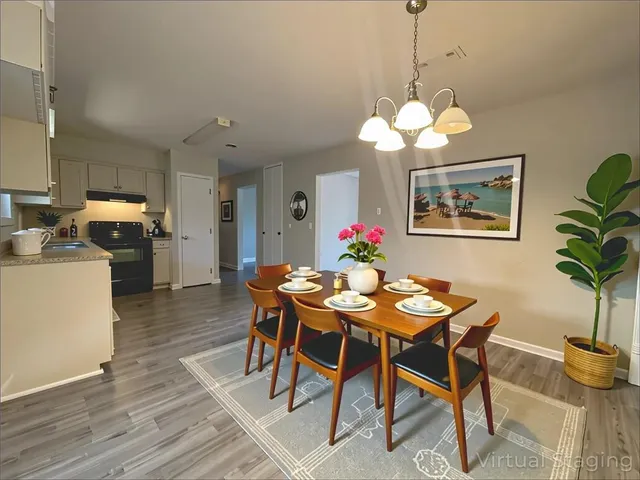 a view of a dining room with furniture and chandelier