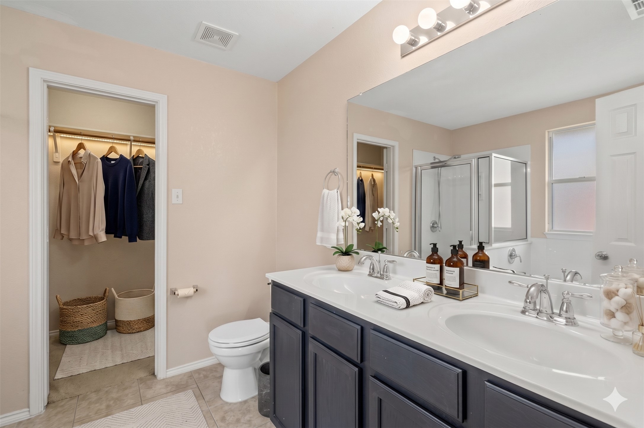 20224 Merlin Falcon Trail Pflugerville, TX 78660 - Photo 9 of 40 Double vanities and a walk-in closet highlight this well-appointed primary bathroom.