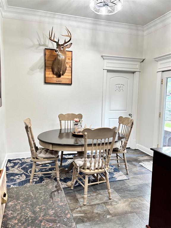 605 Jade Haughton, LA 71037 - Photo 10 of 34 Dining area featuring slate-style flooring, a decorative overhead light fixture, and crown molding