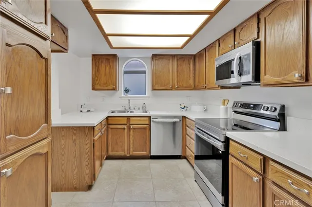 a kitchen with stainless steel appliances granite countertop a sink and a stove top oven