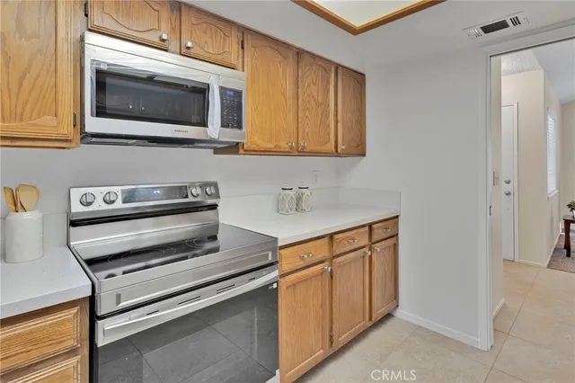 a kitchen with stainless steel appliances a stove microwave and sink