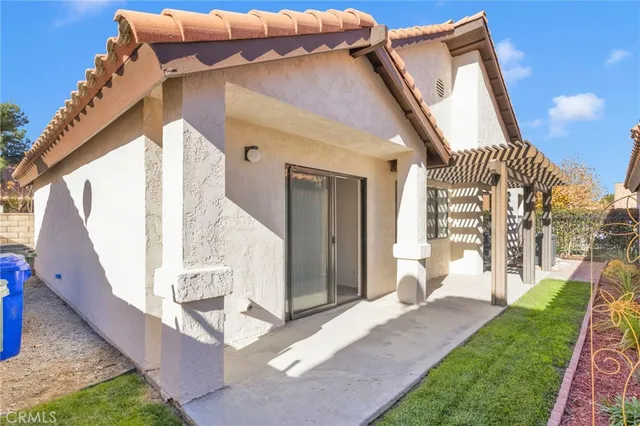 a view of a house with a yard and furniture
