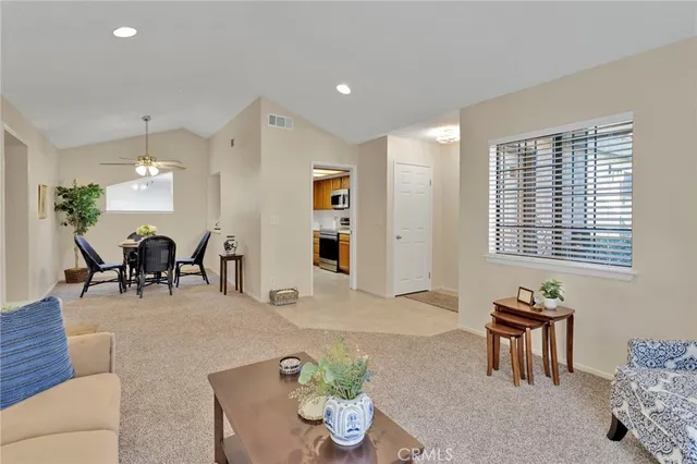 a living room with furniture and floor to ceiling windows