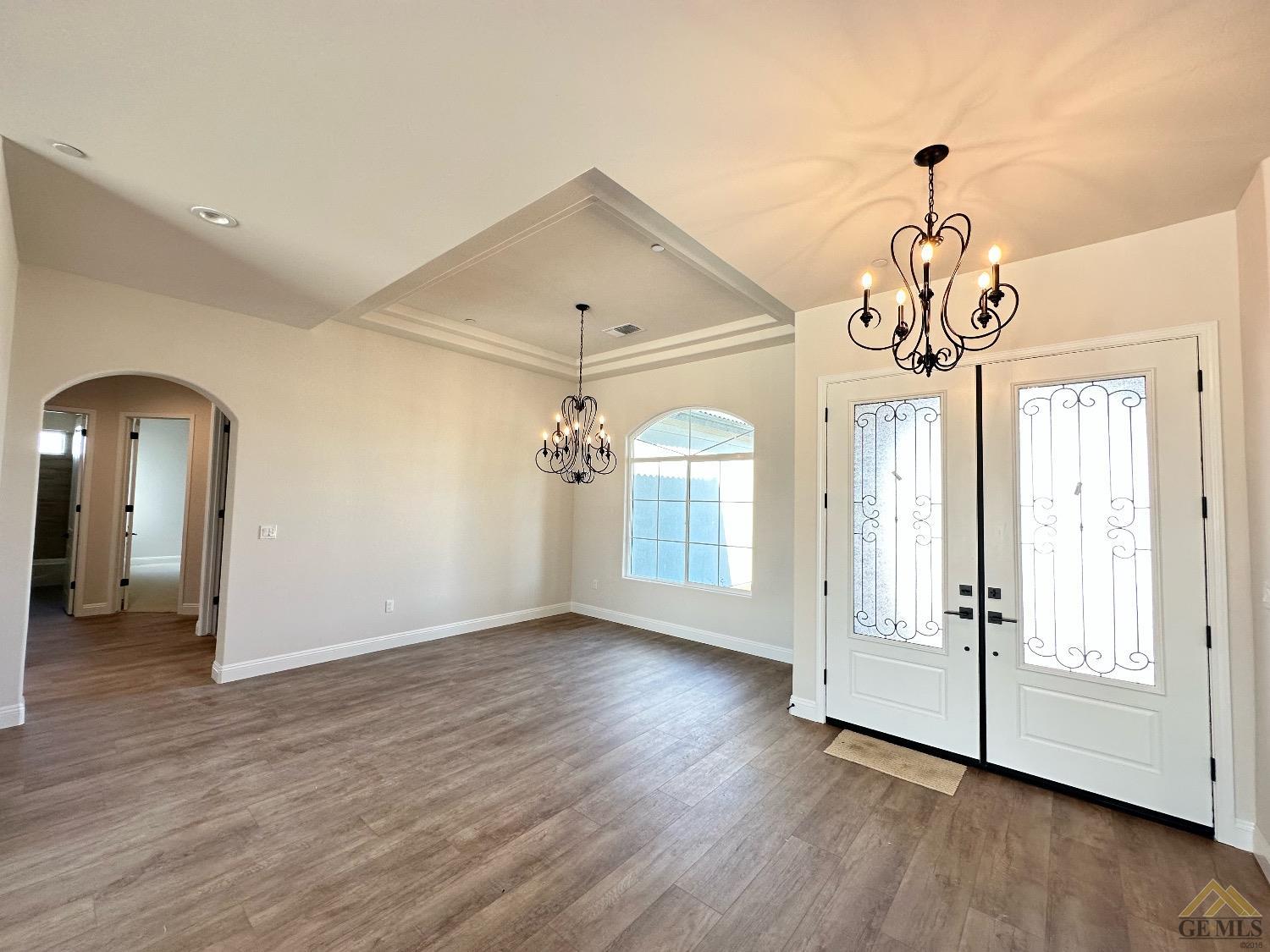 Undisclosed Address Bakersfield, CA 93314 - Photo 12 of 34 a view of empty room with wooden floor and fan