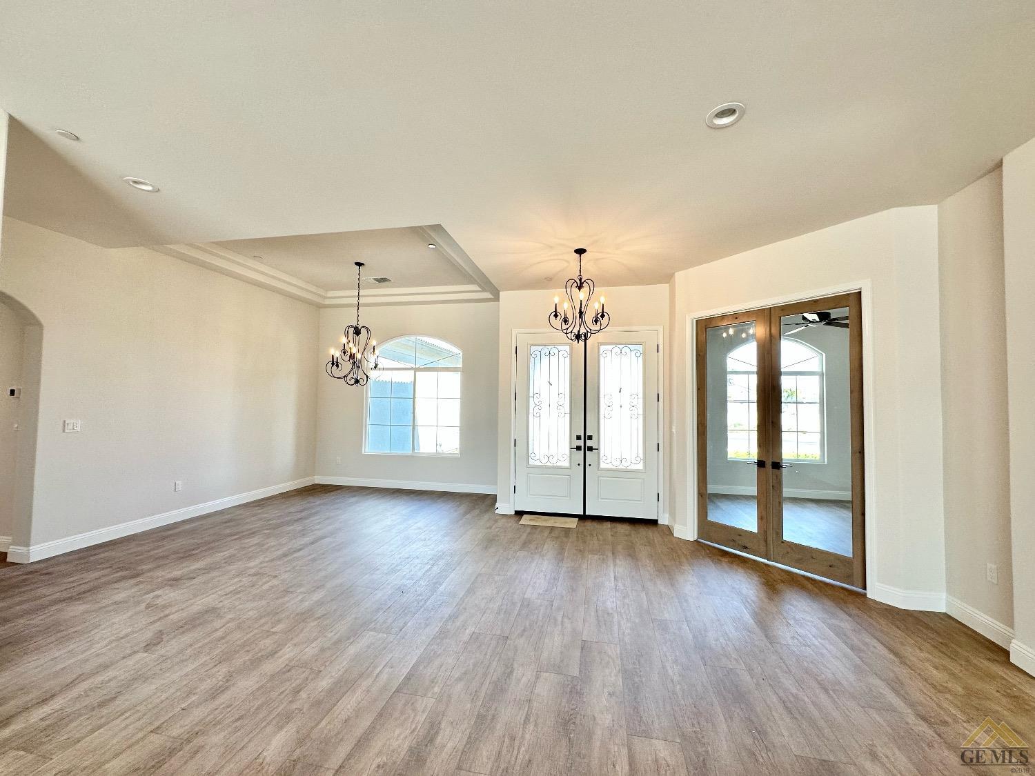 Undisclosed Address Bakersfield, CA 93314 - Photo 13 of 34 an empty room with wooden floor and windows