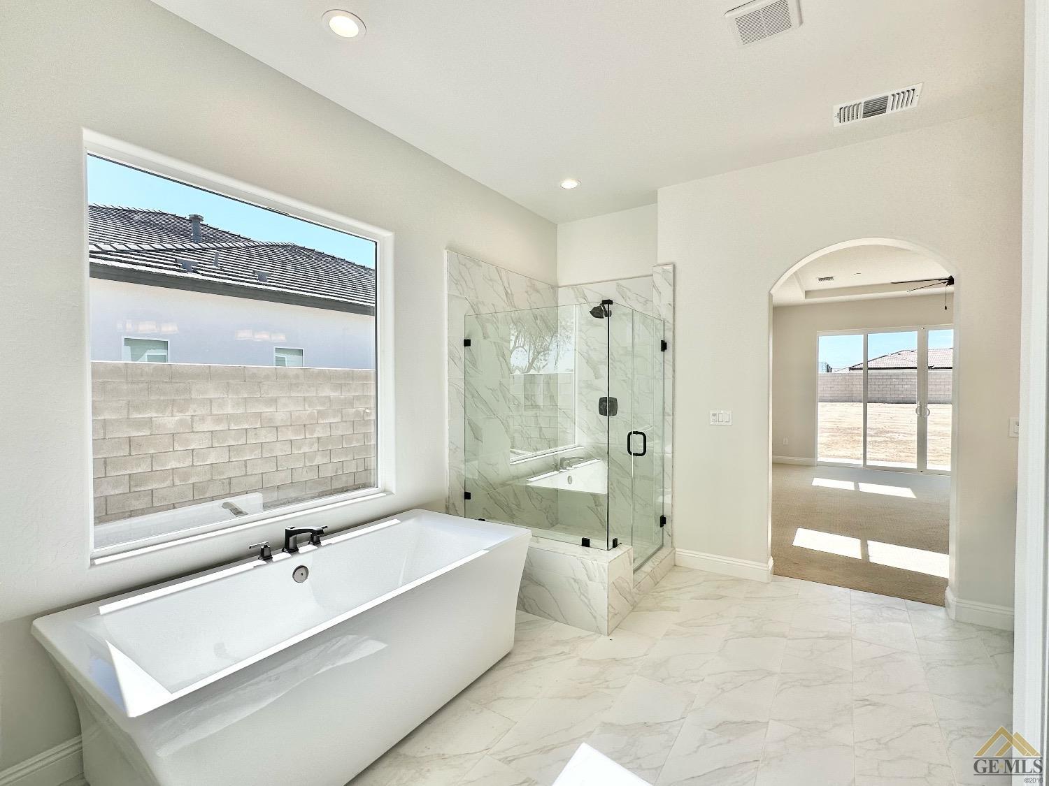 Undisclosed Address Bakersfield, CA 93314 - Photo 16 of 34 a bathroom with a tub shower sink and mirror