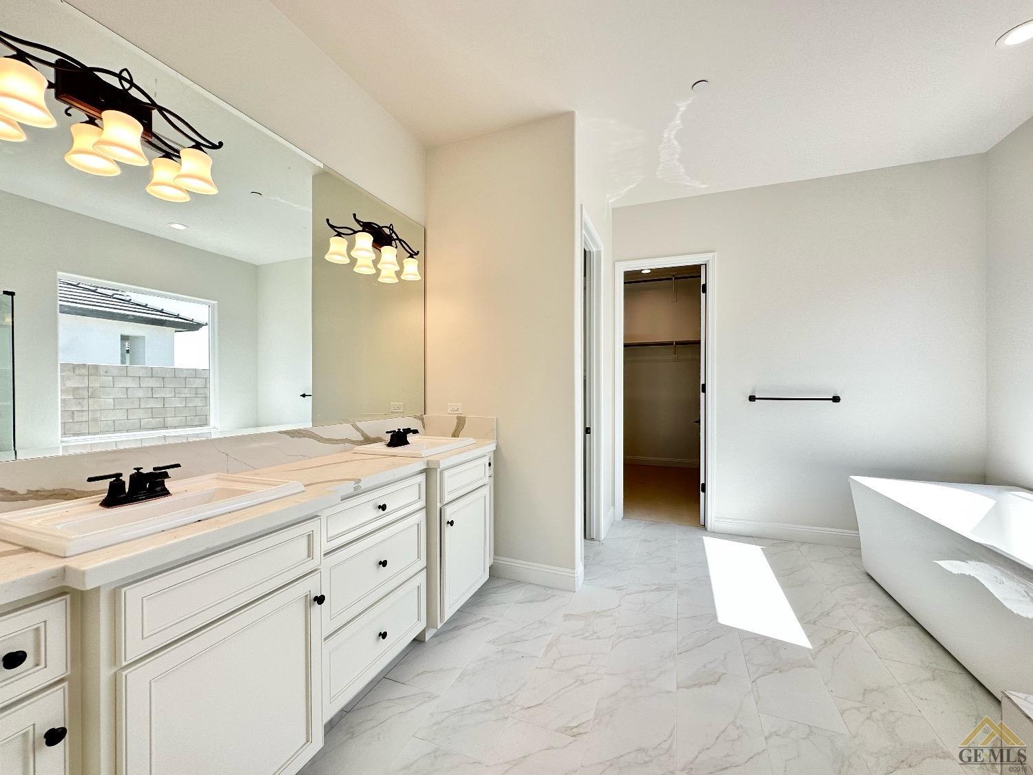 Undisclosed Address Bakersfield, CA 93314 - Photo 18 of 34 a bathroom with a double vanity sink and mirror with shower