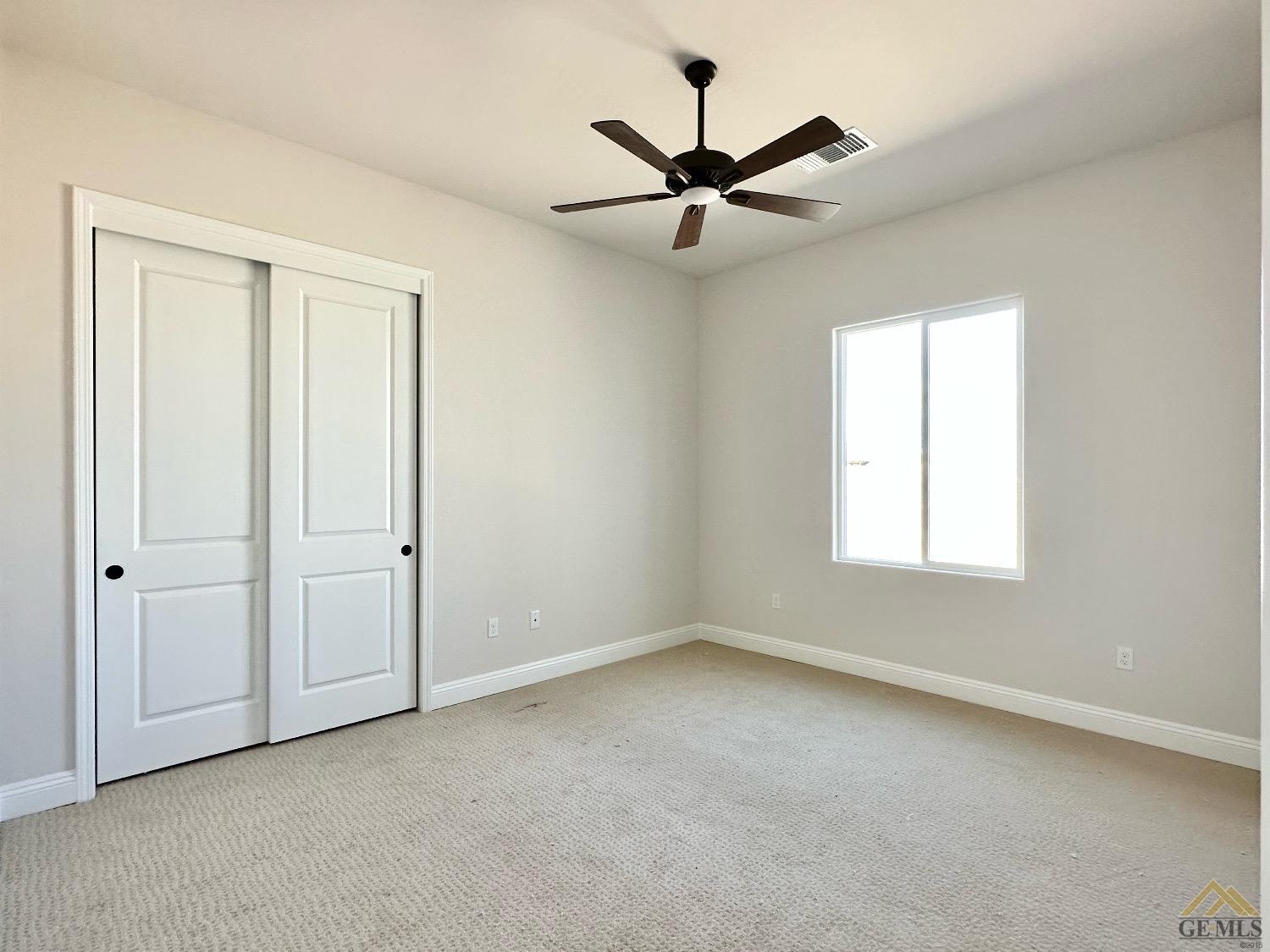 Undisclosed Address Bakersfield, CA 93314 - Photo 23 of 34 an empty room with a window and a fan
