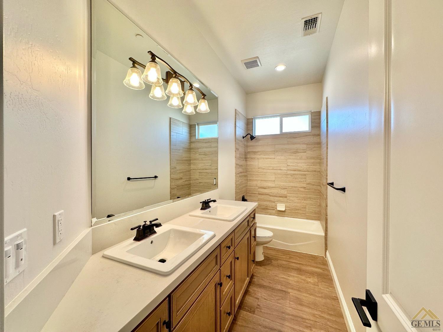 Undisclosed Address Bakersfield, CA 93314 - Photo 24 of 34 a bathroom with a sink mirror and a bathtub