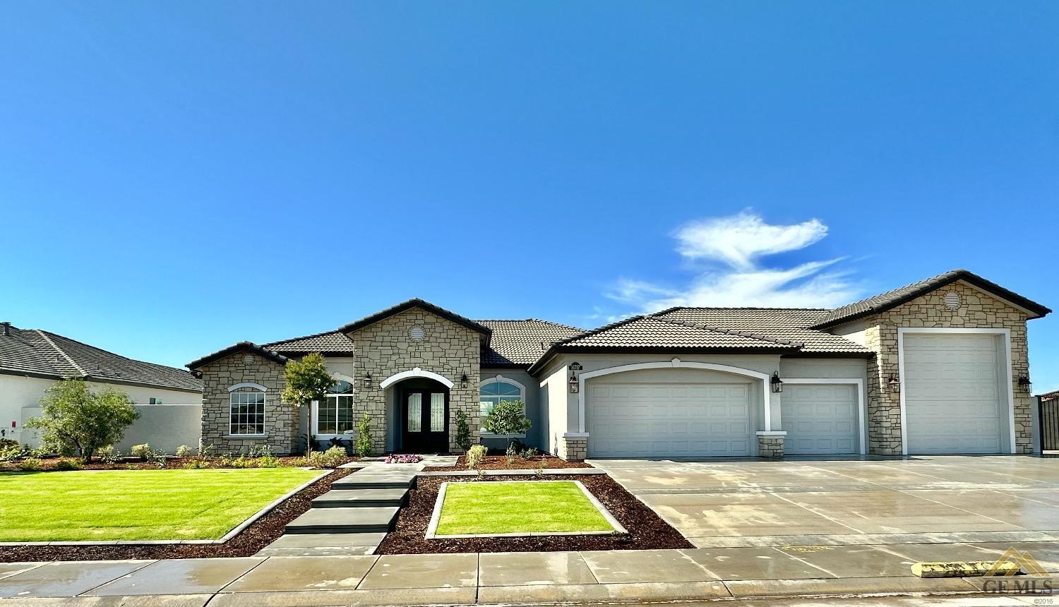 Undisclosed Address Bakersfield, CA 93314 - Photo 3 of 34 a front view of a house with a yard and garage