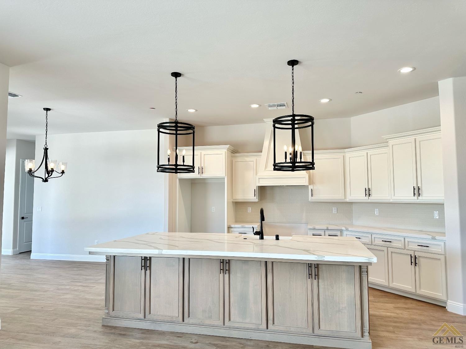 Undisclosed Address Bakersfield, CA 93314 - Photo 4 of 34 a kitchen with kitchen island a counter top space appliances a sink and cabinets