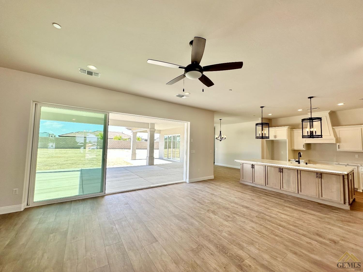 Undisclosed Address Bakersfield, CA 93314 - Photo 6 of 34 a view of an empty room with a window and wooden floor