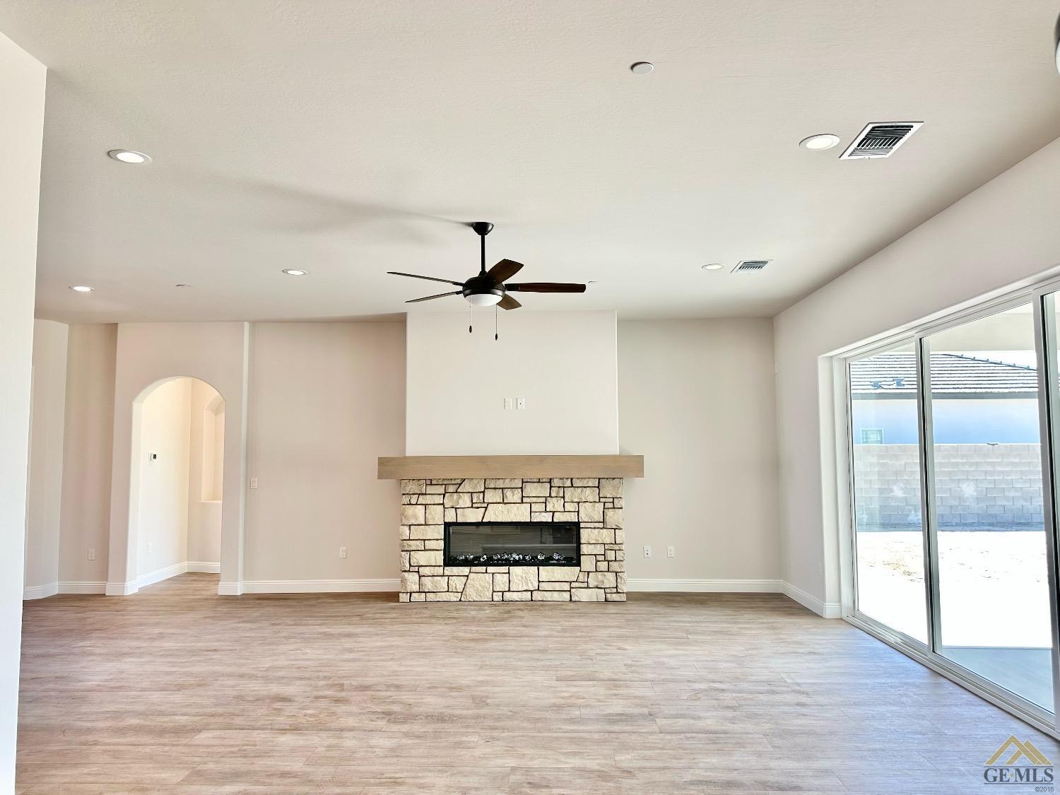 Undisclosed Address Bakersfield, CA 93314 - Photo 9 of 34 a view of an empty room with a fireplace and a window
