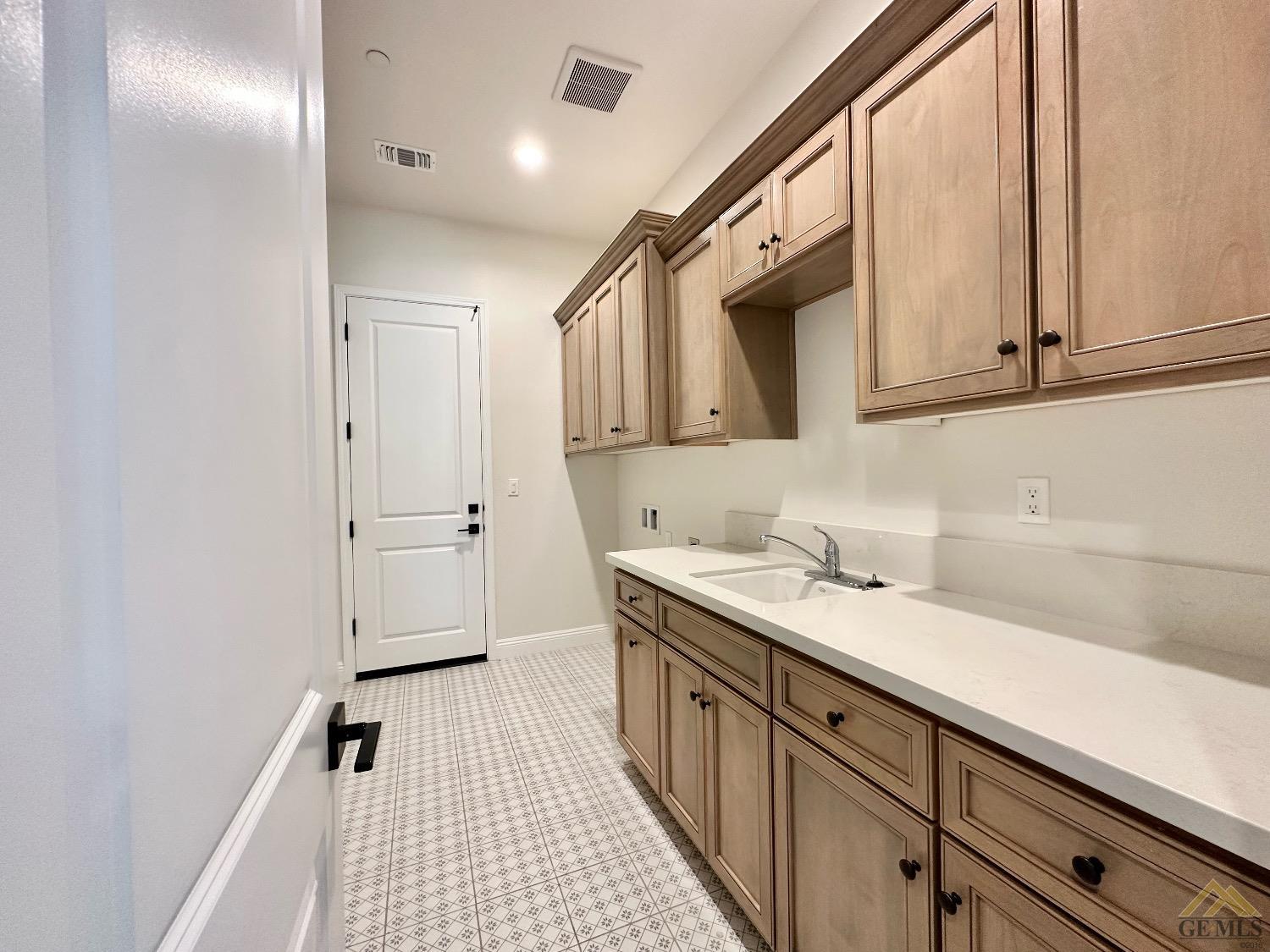 Undisclosed Address Bakersfield, CA 93314 - Photo 10 of 34 a kitchen with a sink and cabinets