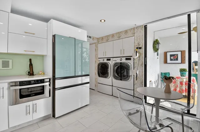 a kitchen with stainless steel appliances kitchen island granite countertop a sink and cabinets