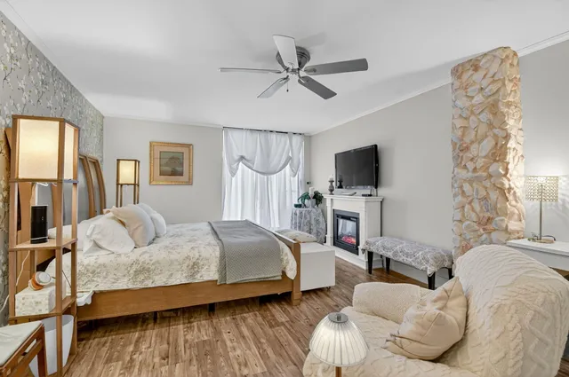 a bedroom with a large bed and a chandelier