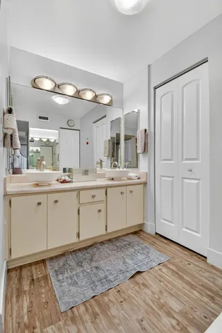a bathroom with a sink a mirror and a shower