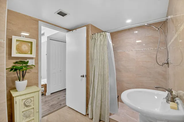 a living room with furniture and floor to ceiling windows