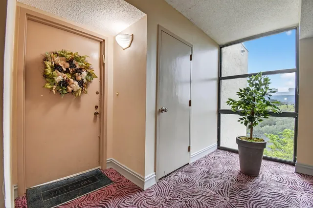 a front view of a building with a garden