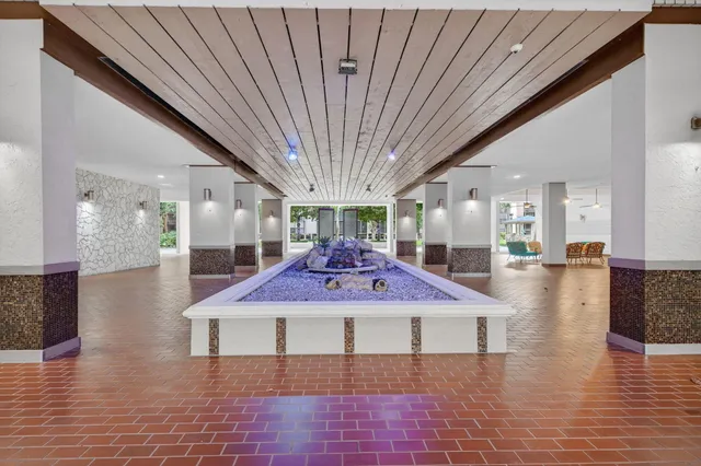 a bathroom with a shower and a tiled wall