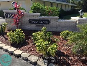 1166 6th Avenue, Unit A1 Vero Beach, FL 32960 - Photo 1 of 13 a sign that is sitting in front of flowers