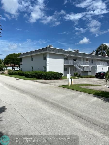 1166 6th Avenue, Unit A1 Vero Beach, FL 32960 - Photo 2 of 13 a front view of a house with a yard
