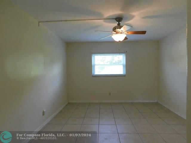 1166 6th Avenue, Unit A1 Vero Beach, FL 32960 - Photo 5 of 13 an empty room with a window