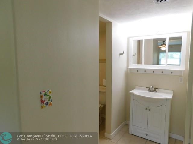 1166 6th Avenue, Unit A1 Vero Beach, FL 32960 - Photo 7 of 13 a bathroom with a sink and a mirror