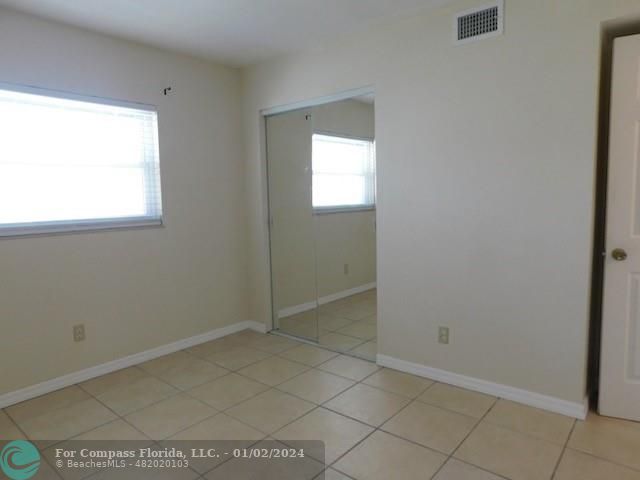 1166 6th Avenue, Unit A1 Vero Beach, FL 32960 - Photo 8 of 13 a view of an empty room with window