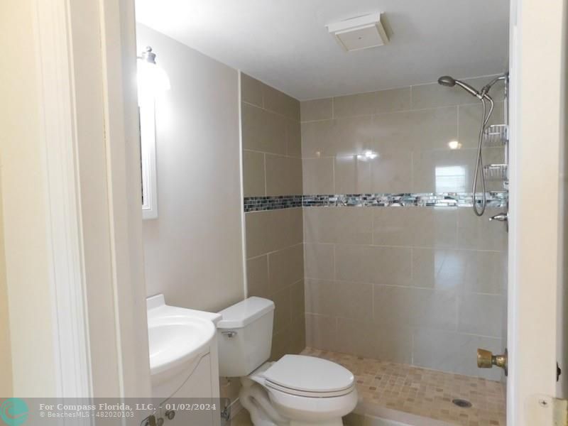1166 6th Avenue, Unit A1 Vero Beach, FL 32960 - Photo 10 of 13 a white toilet sitting next to a bathroom sink
