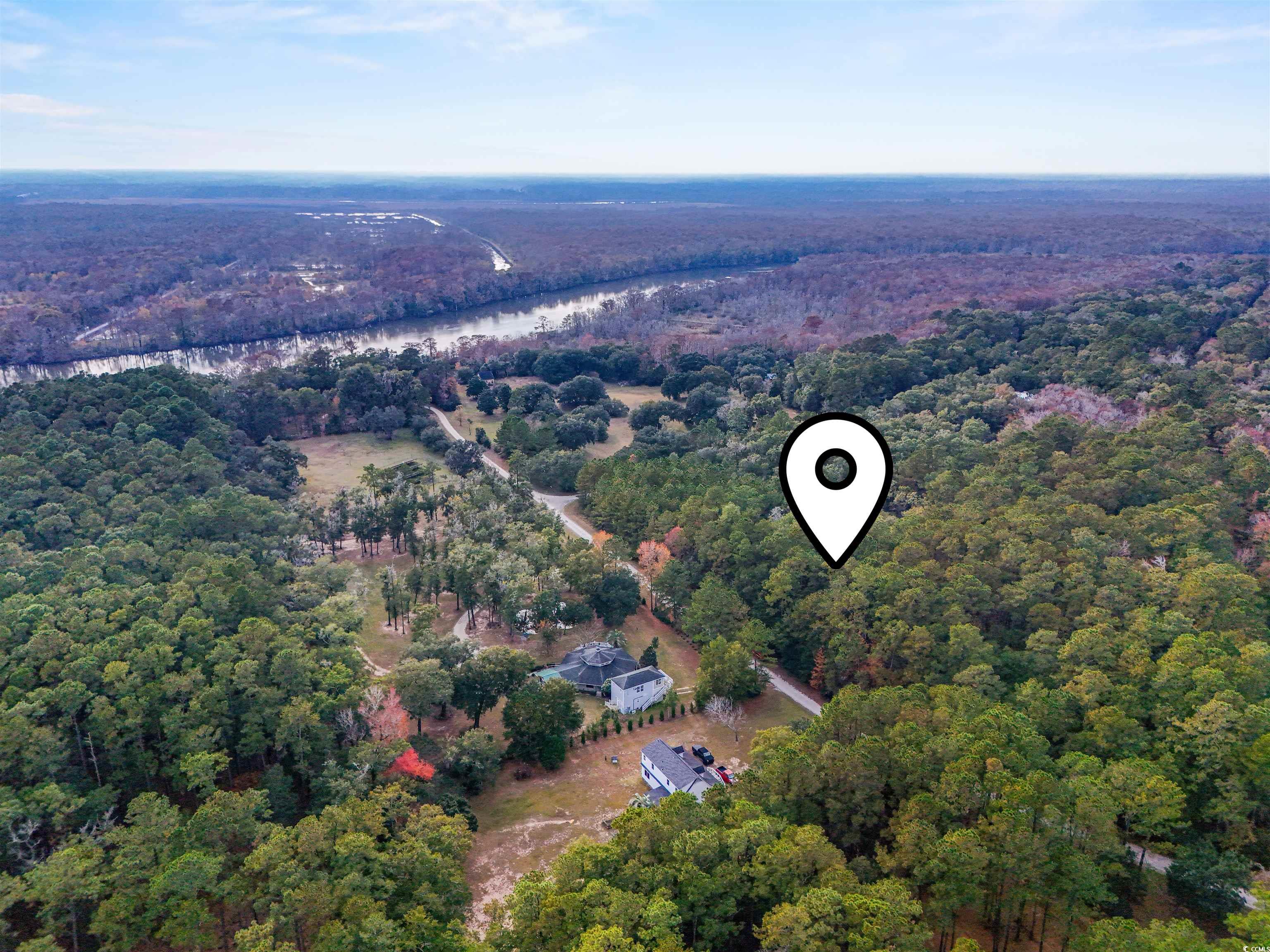 7 Santee Landing Road Georgetown, SC 29440 - Photo 11 of 11 Aerial view of property and surrounding area with a heavily wooded area and a large body of water