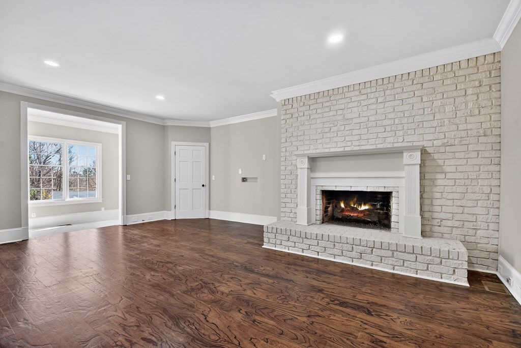 229 Crossroads Church Road Ellijay, GA 30540 - Photo 26 of 71 a view of an empty room with wooden floor fireplace and a window