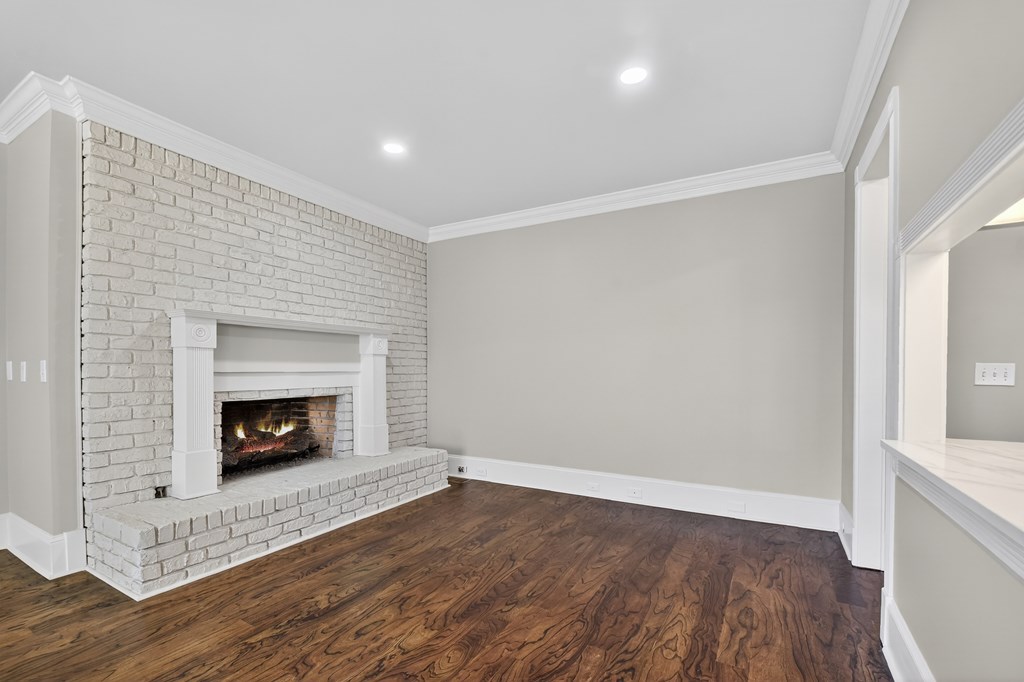 229 Crossroads Church Road Ellijay, GA 30540 - Photo 29 of 71 an empty room with wooden floor and fireplace