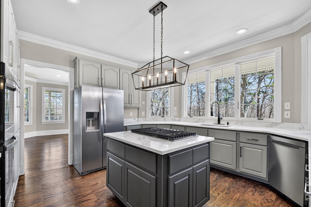 229 Crossroads Church Road Ellijay, GA 30540 - Photo 32 of 71 a kitchen that has a kitchen island wooden cabinets and stainless steel appliances