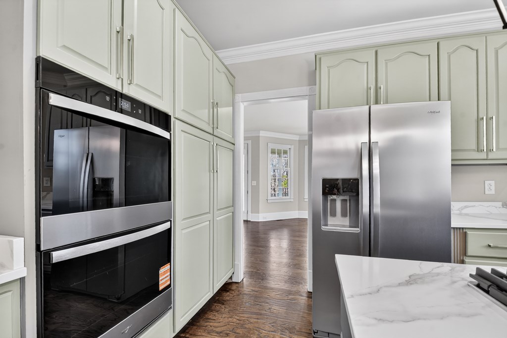 229 Crossroads Church Road Ellijay, GA 30540 - Photo 34 of 71 a kitchen with stainless steel appliances kitchen island granite countertop a refrigerator a stove and a sink with wooden floor