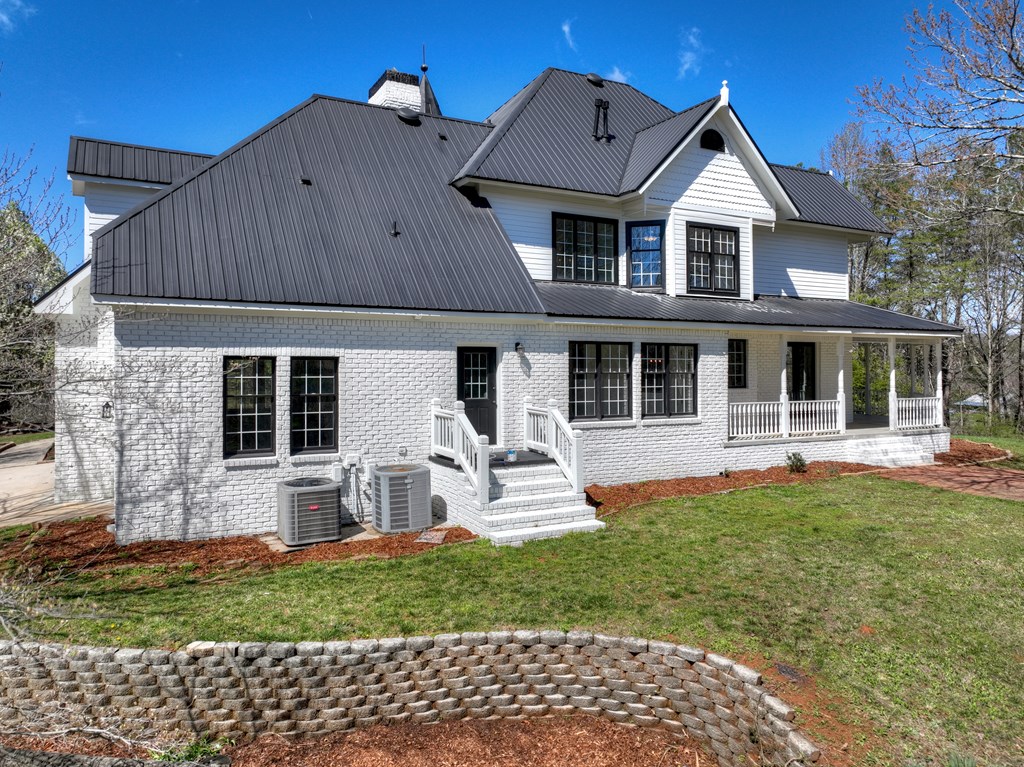 229 Crossroads Church Road Ellijay, GA 30540 - Photo 5 of 71 a front view of a house with a yard and porch