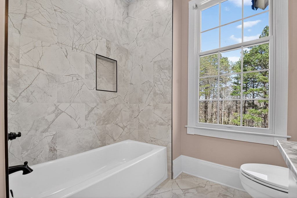 229 Crossroads Church Road Ellijay, GA 30540 - Photo 56 of 71 a bathroom with a bathtub and window