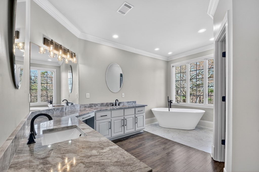 229 Crossroads Church Road Ellijay, GA 30540 - Photo 61 of 71 a spacious bathroom with a double vanity sink a mirror a bathtub and next to a window